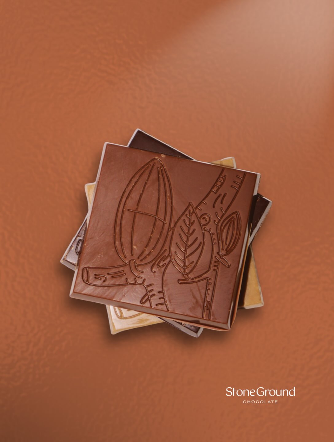 Cacao pod design embossed on chocolate slabs against a Rooibos background